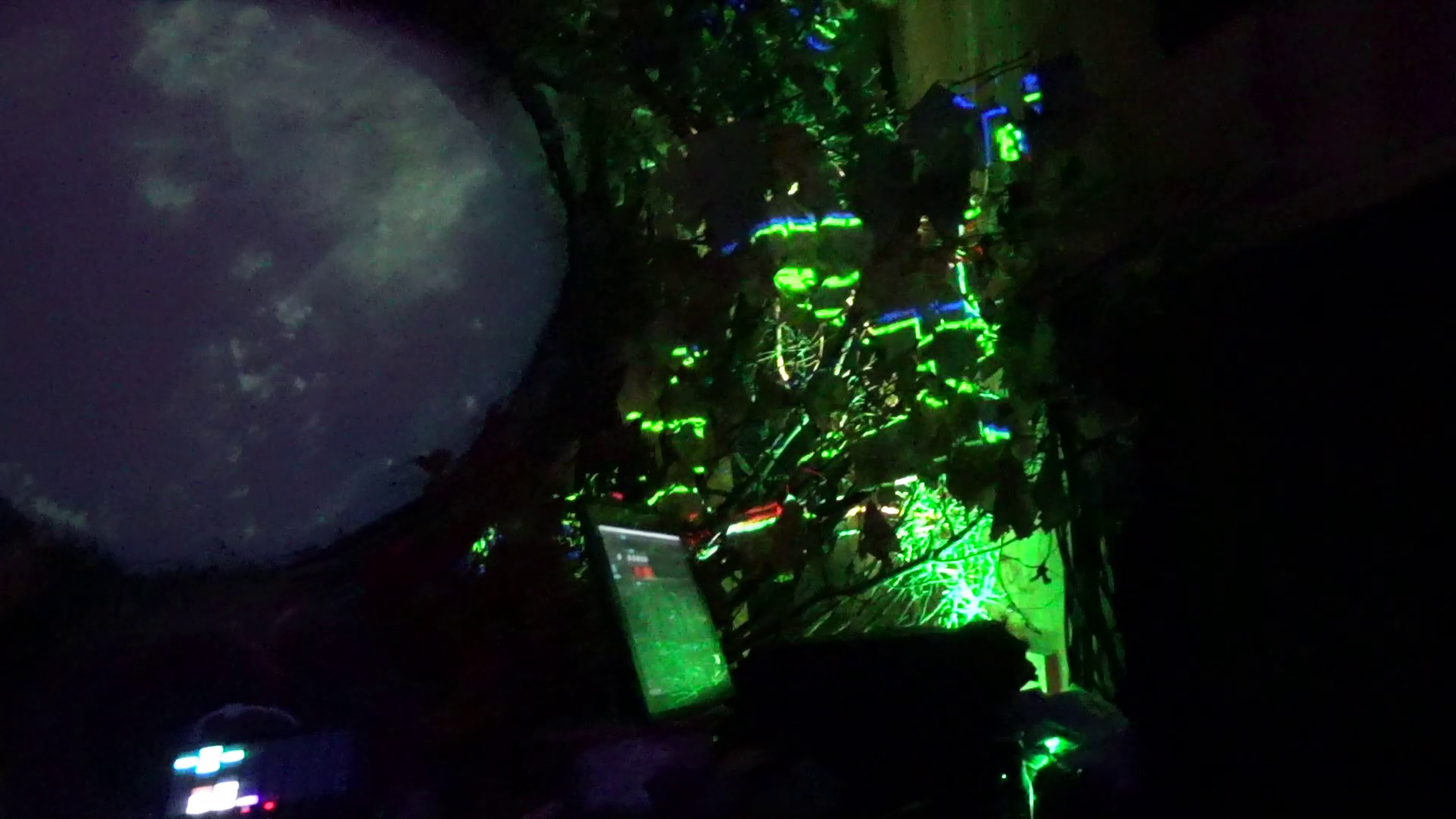 Glowing rainbow lights like glowing mushrooms lights around computer and shimmering portal surface